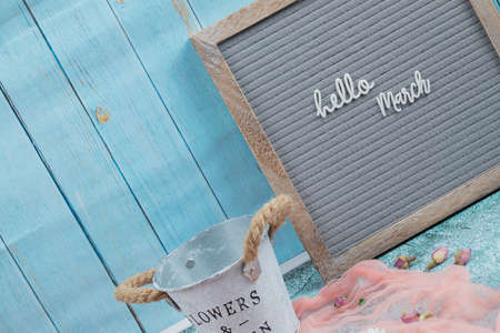 Hello march phrase embedded on grey background with flower blossoms aroundの写真素材