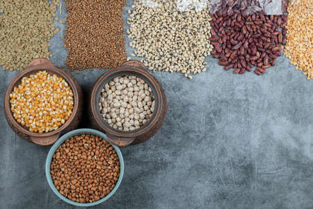 Assortment of raw beans, peas and corns on a marble backgroundの写真素材