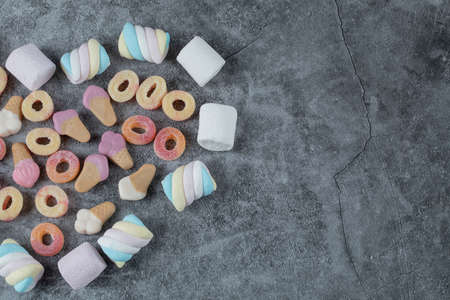 Mix of marshmallow and jellybeans on the marble background