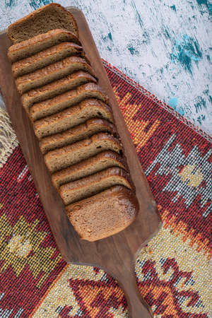 A wooden cutting board with slices of bread