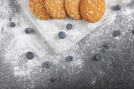 Delicious sweet biscuits on wooden board with blueberriesの写真素材