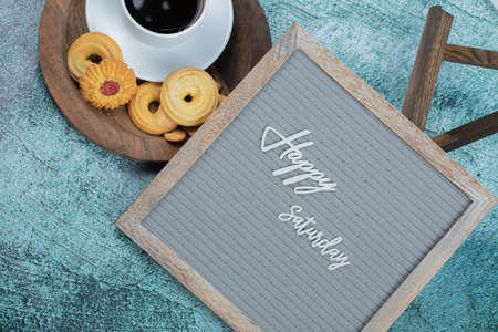 Happy saturday poster embedded on grey background with cookiesの写真素材