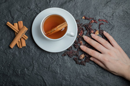 A cup of tea with cinnamon sticks and infusionの写真素材