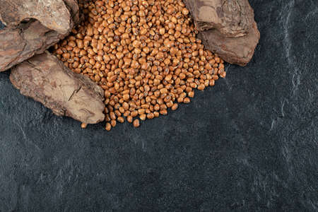 Many of uncooked brown kidney beans on a dark background
