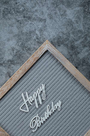 Happy birthday phrase embedded on grey backgroundの写真素材