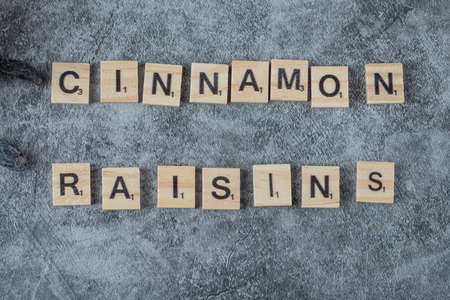 Cinnamon writing with wooden dices on the groundの写真素材