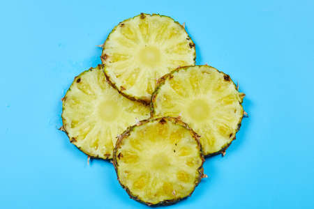 Slices of pineapple on blue backgroundの写真素材