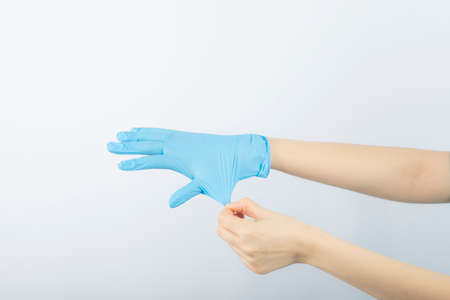 Female doctor wearing medical gloves for protective epidemic Virus