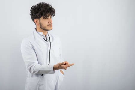 Professional doctor touching with finger a modern interface in his officeの写真素材