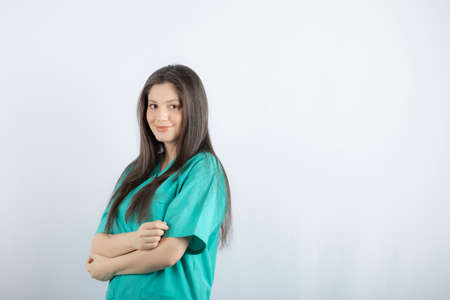 Young nurse crossed her hand and looking at cameraの写真素材