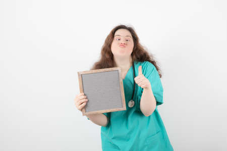 Image of a young girl in green uniform with a frame showing a thumb up