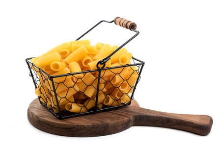 Wicker basket of raw tube pasta isolated on white backgroundの写真素材