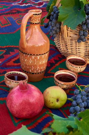 Red pomegranate and pear wine in pottery cups