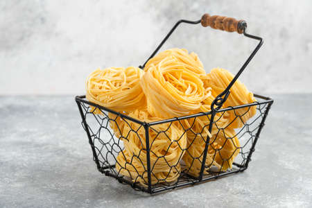 Uncooked noodle rolls in a metallic trayの写真素材