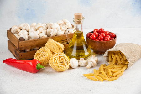 Set of mushrooms, extra virgin olive oil, pastas, cherry tomatoesの写真素材