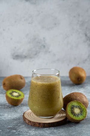 Many of kiwi fruits with a glass cup of juiceの写真素材