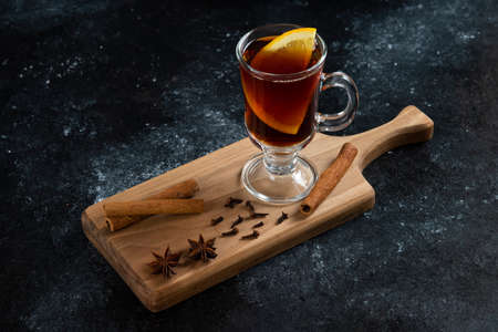 A glass cup of tea and with cinnamon sticks and star anisesの写真素材
