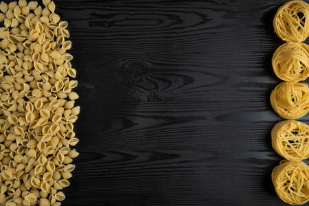 Italian pasta varieties on the black tableの写真素材