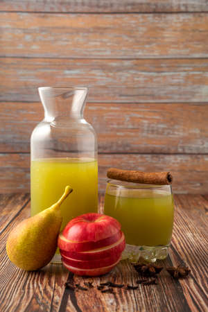 Green pear and red apple with a glass of juiceの写真素材