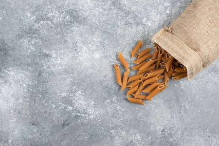 Pastas in a rustic bag with green chili peppers around