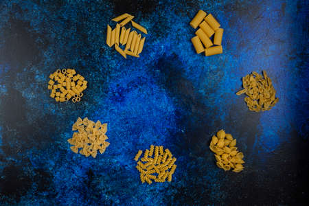 Pasta varieties isolated on blue backgroundの写真素材