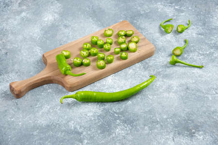 Sliced jalapeno peppers on wooden marble boardの写真素材