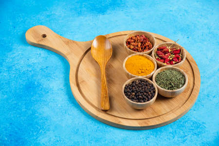 Various organic spices on wooden boardの写真素材