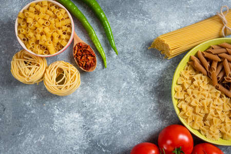 Variety of spices, vegetables and raw beans on blue backgroundの写真素材