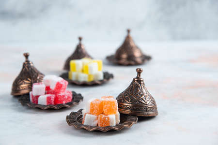 Vertical photo of sweet candies. Colorful marmalade on grey background