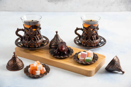 Close up photo of Turkish tea set. Fragrant tea and sweet candiesの写真素材