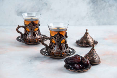 Traditional tea set fresh tea with dry dateの写真素材