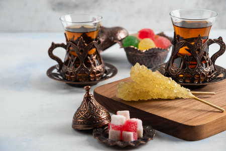 Close up photo of Turkish tea set. Sweet candies and fragrant teaの写真素材