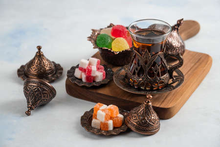 Close up photo of traditional tea set. Sweet candies and fragrant teaの写真素材