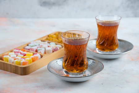 Close up photo of Two glass tea and turkish delightsの写真素材
