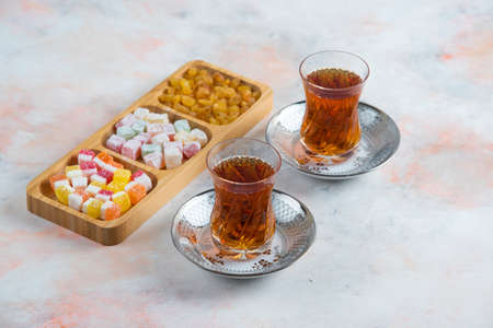 Two glass tea and turkish delights on backgroundの写真素材