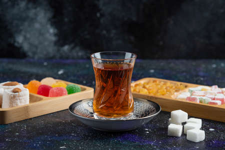 Glass off tea and delights. Lokum, marmalade and sugarの写真素材