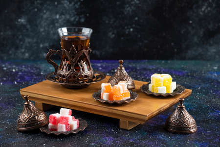 Tea set with Turkish delights on wooden boardの写真素材