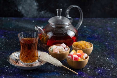 Tea set with Turkish delights on blue backgroundの写真素材