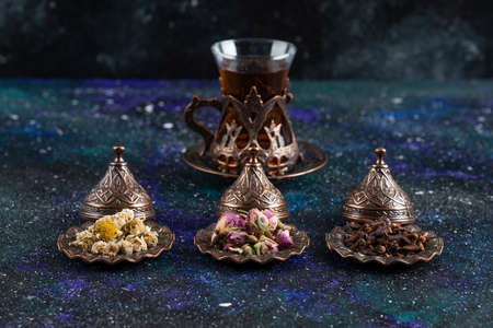 Fragrant tea behind of various herbs on grey backgroundの写真素材