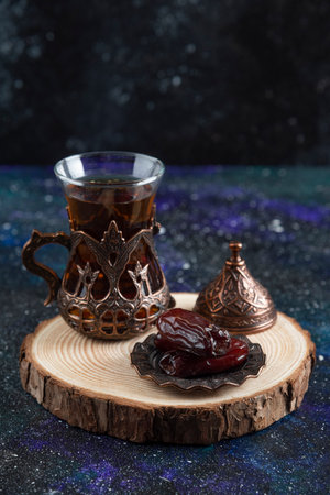 Vertical photo of Hot tea and dry dateの写真素材