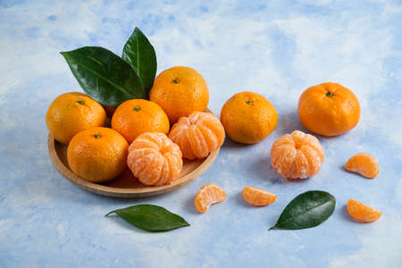 Season fruit. Peeled or whole clementine mandarinsの写真素材