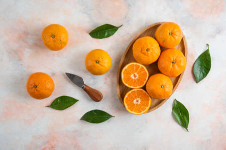 Organic pile of clementine mandarins over colorful backgroundの写真素材