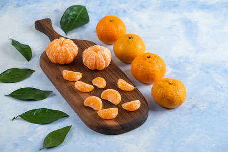 Close up photo of fresh juicy mandarins with leavesの写真素材