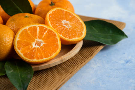 Close up photo of half cut fresh clementine mandarinの写真素材