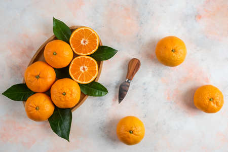 Top view of clementine mandarins over wooden plateの写真素材
