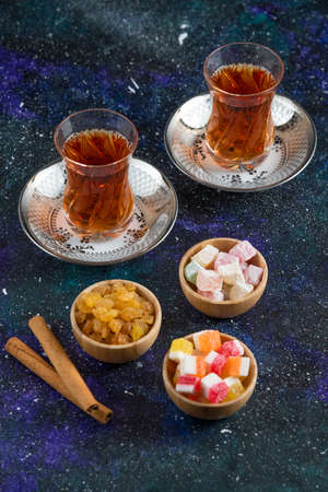 Vertical photo of Fragrant tea and delights on blue backgroundの写真素材