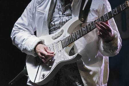 A band member at a First Night Celebration in New Bern ,North Carolina demnstrates his skill playing an instrumental solo on the electric guitar.の写真素材