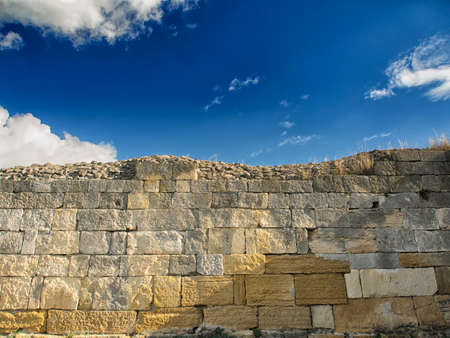 Dramatic blue sky with white clouds over the ruins of the ancient greek colony of Histria, on the shores of Black Sea. Histria is the oldest urban settlement on Romanian territoryの写真素材