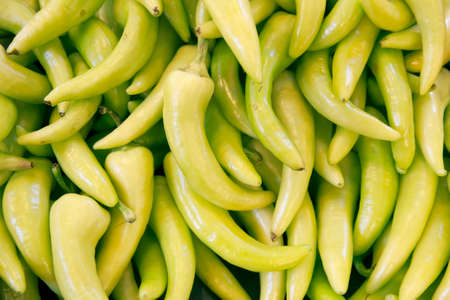 pile of organic paprikas at market stallの写真素材