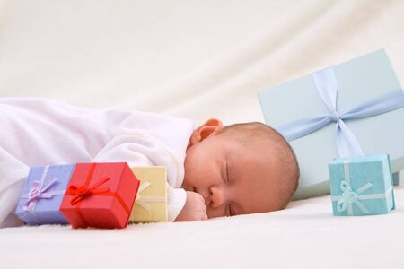 Colorful gift boxes with sleeping babyの写真素材